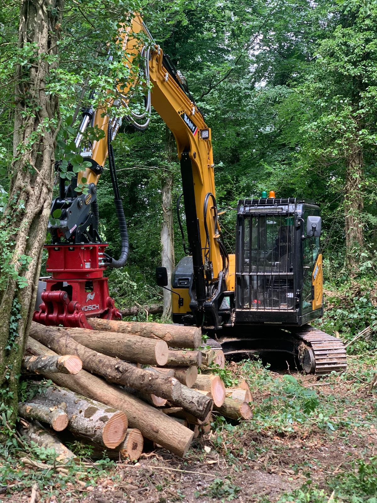 SANY excavator with red Vosch attachment and cut timber